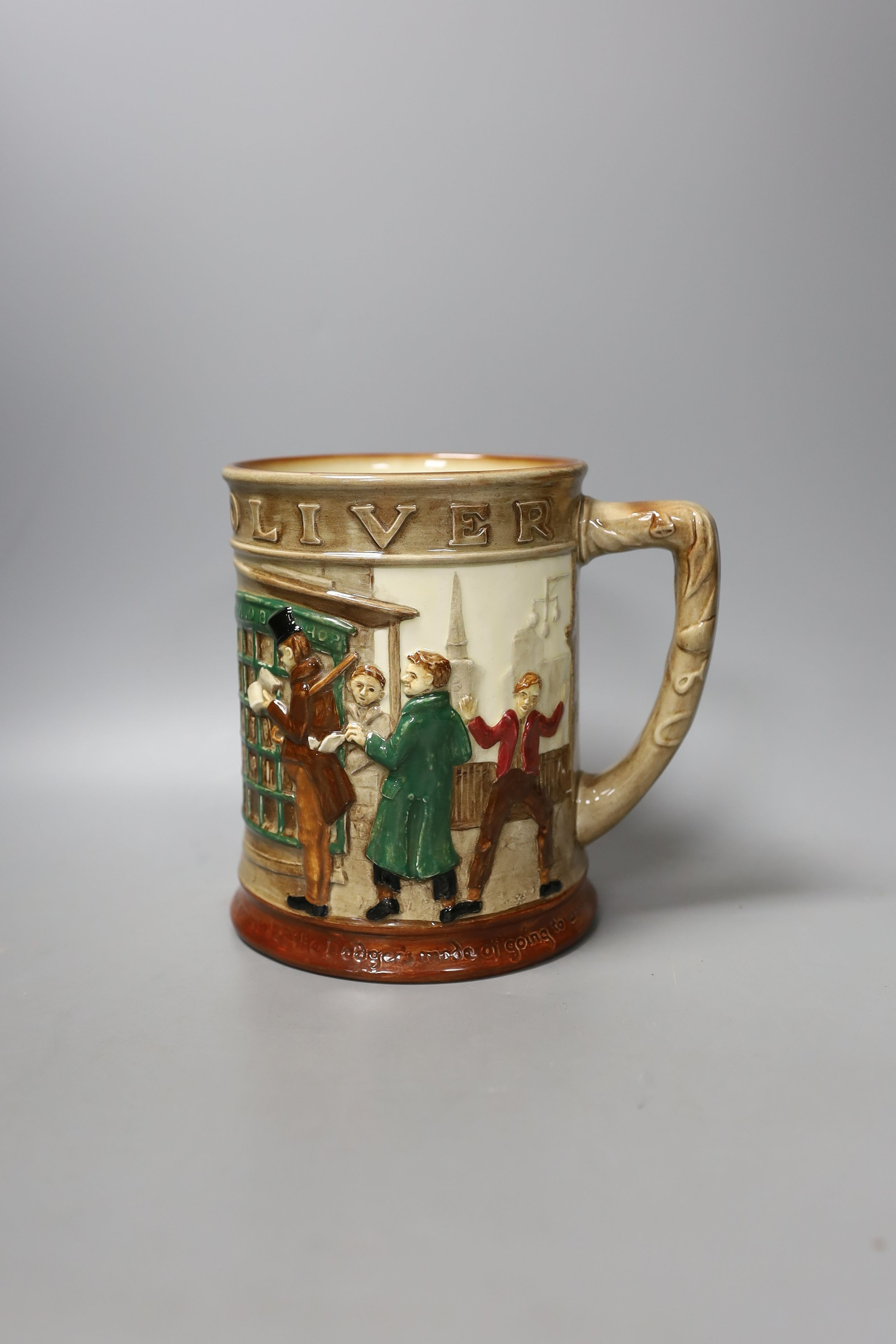 A Doulton Oliver Twist mug and eight Portuguese leaf dishes